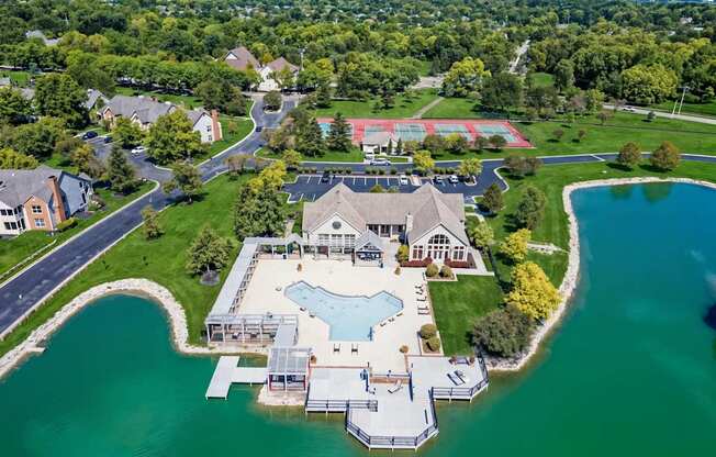 A large house with a pool is surrounded by water.