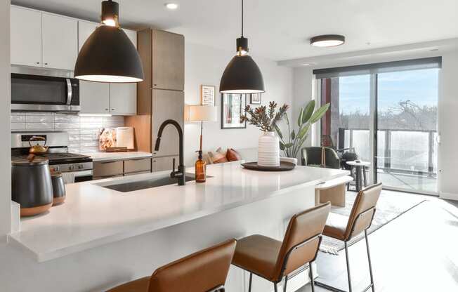 a kitchen with a large white counter top and a large window at The Bohen Apartments , Minneapolis, MN, 55408