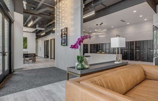 a lobby with a brown couch and a table