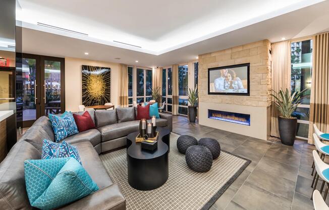 Lounge with fireplace and TVs offering a warm setting for gatherings.