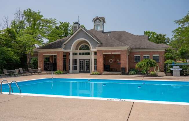 a swimming pool with a brick building in the background