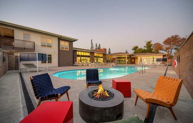 Poolside Fireplace Seating with colorful chairs at Sierra Gateway Apartments