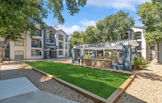 Outdoor Grass Area & Covered Patio BBQ Area at Allure North Dallas Apartments in Dallas, TX.
