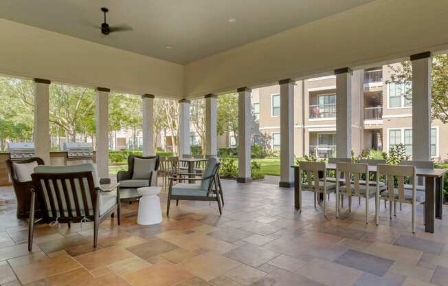an outdoor patio with tables and chairs at Summerwind, Texas, 77584