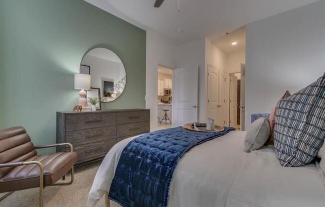 a bedroom with a bed and a ceiling fan at Flats at West Broad Village, Virginia, 23060
