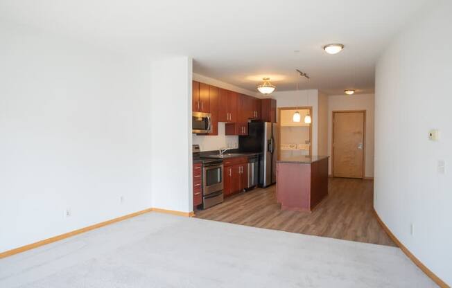 A kitchen area with a refrigerator, microwave, and oven.