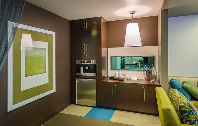 a kitchen and living room in a hotel room