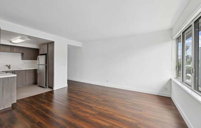 A kitchen with a refrigerator, sink, and wooden floors.at Hollywood Ardmore, Los Angeles California