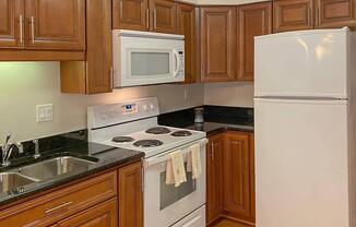 a kitchen with stainless steel appliances and wooden cabinets