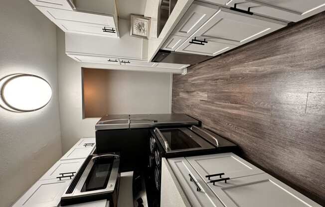Kitchen with hardwood floors and white cabinets