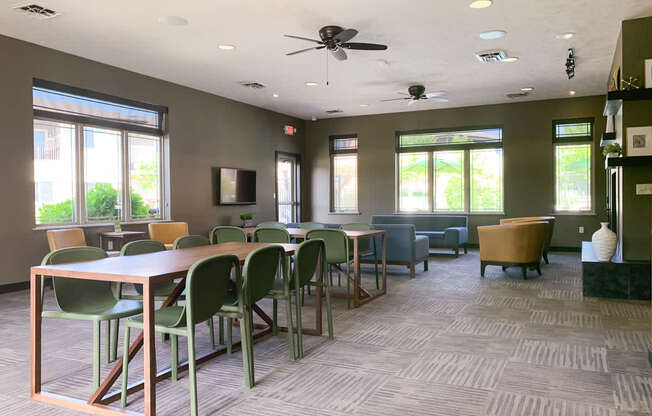 a conference room with tables and chairs and a ceiling fan