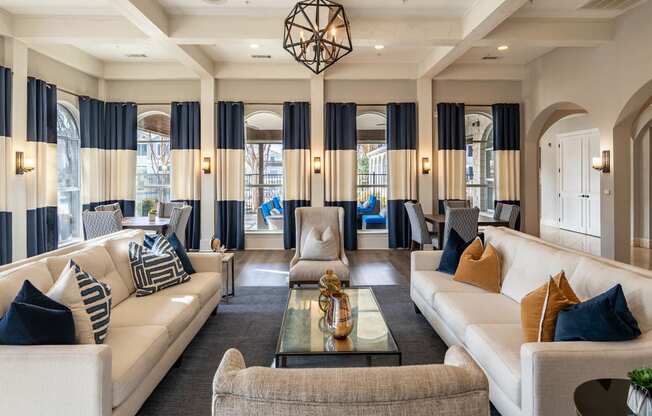a living room with couches and chairs and a table  at Orion Prosper Lakes, Texas, 75078