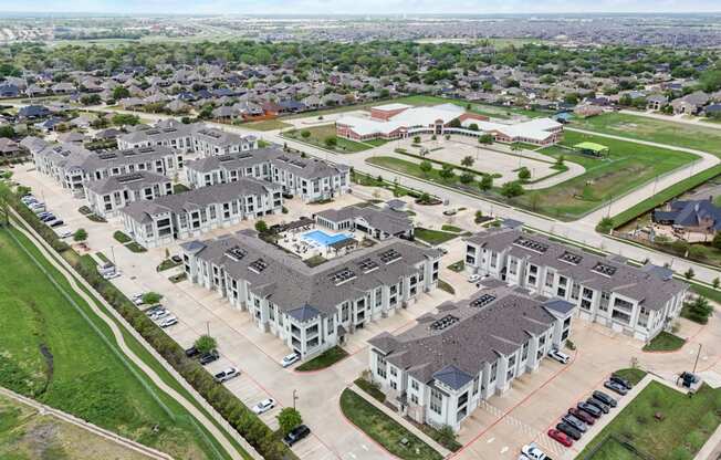 an aerial view of a group of houses and a parking lot