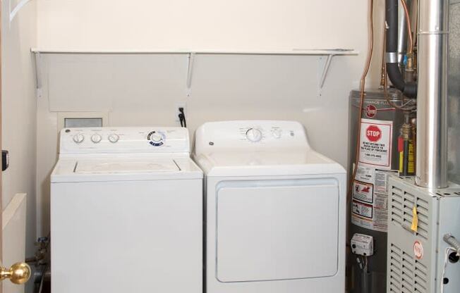 Laundry room with full size washer and dryer and shelving