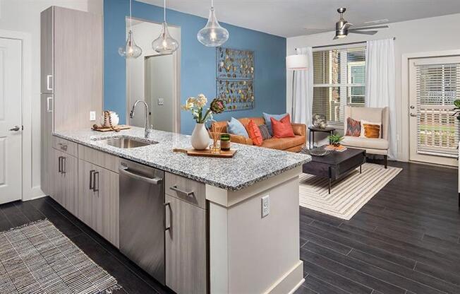 a kitchen with an island and a living room at Promenade at Newnan Crossing, Newnan, GA 30265