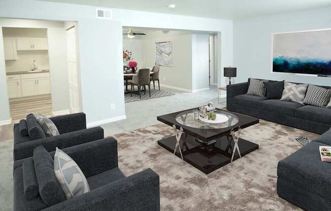 a living room with couches and chairs and a table