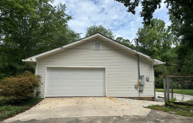 Prime 30265 location! Huge back yard, large wood shop in basement, large grass area & storage building, LVP flooring, large master suite, custom closets!