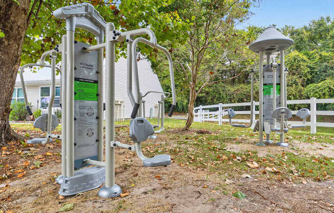 A set of outdoor exercise equipment is located in a park.at Lofts of Wilmington, Wilmington, North Carolina