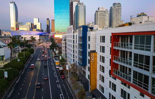 a view of a busy city street with tall buildings