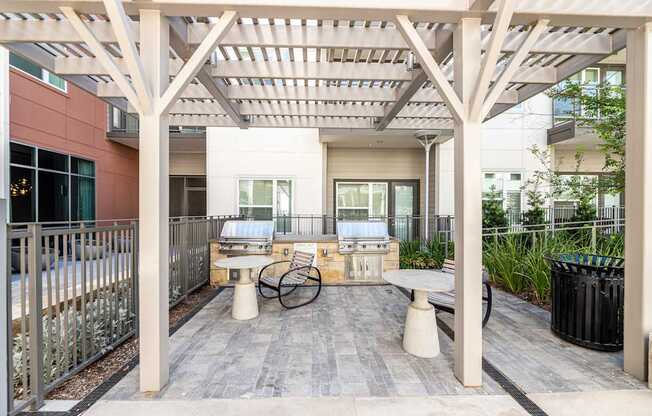 A patio with a table and chairs under a roof.