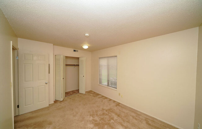 Spacious Bedroom with Large Window at Madeira Apartments in Kalamazoo, MI