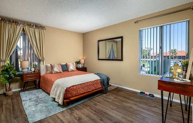 A bedroom with a large bed and a window with a view of the outside.