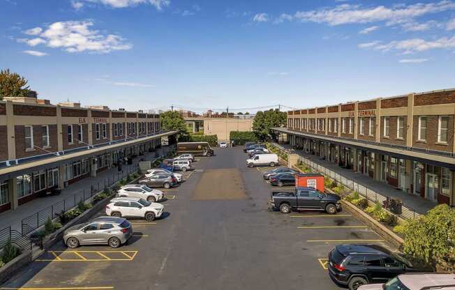an aerial view of a parking lot with cars and buildings at The Lofts at Elk Terminal, Buffalo, NY, 14204