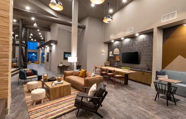 a living room with couches and chairs and a tv