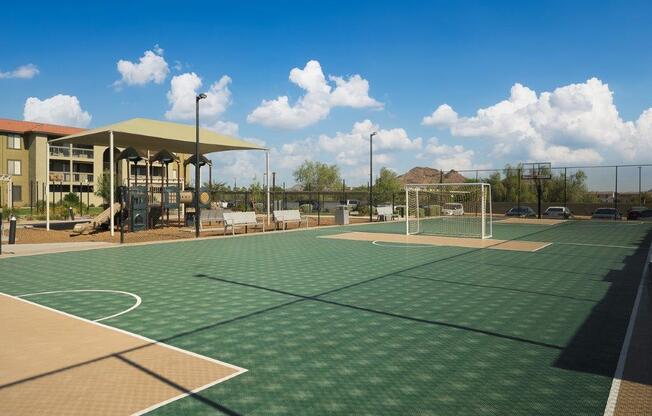 a tennis court with a building in the background