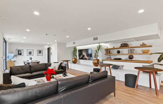a living room with white walls and hardwood flooring