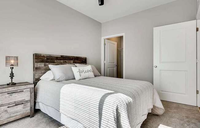 a bedroom with a bed and a closet. Circle Pines, MN Lexington Lofts