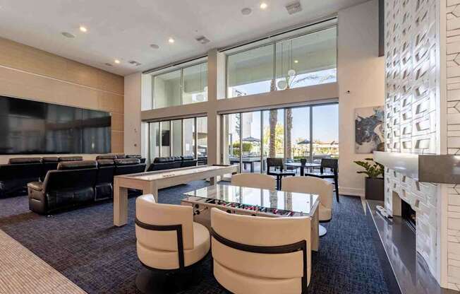 a game room with a foosball table and chairs
