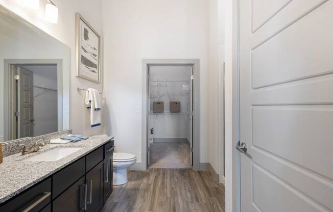 a bathroom with a shower and a toilet and a sink