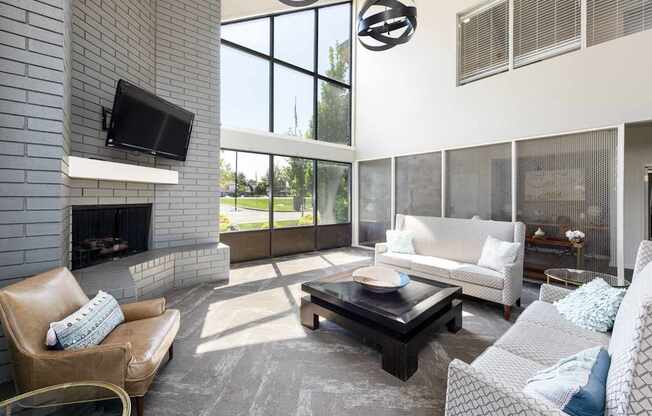 a living room with a couch and a table and a fireplace