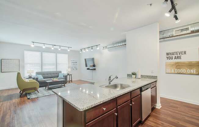 kitchen with an island and a living room in the background