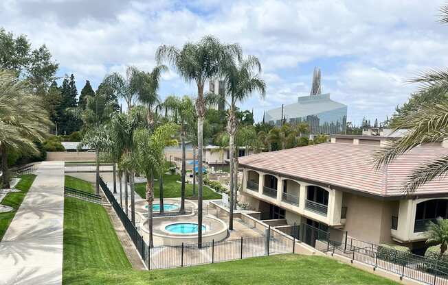 A pool surrounded by a fence and trees.