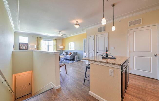 a kitchen with an island and a living room with a couch