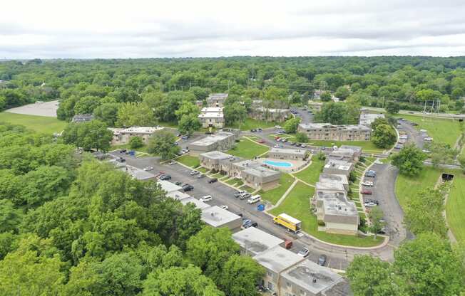 an aerial view of a city with cars parked in a parking lot