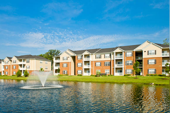 Apartment buildings overlooking pond and fountain