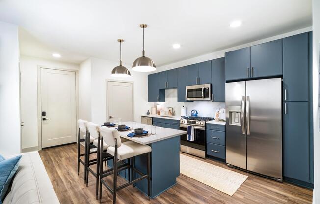 A spacious kitchen with a central island, full-size appliances, and streamlined cabinetry offers an additional finish option, designed to support your individualized daily routine.