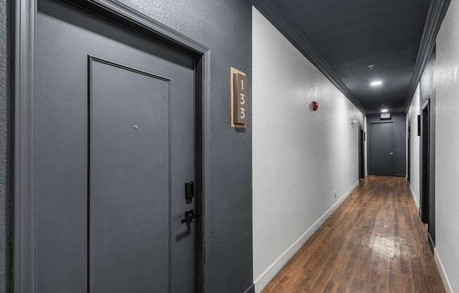 A hallway with a door on the left and a door on the right.