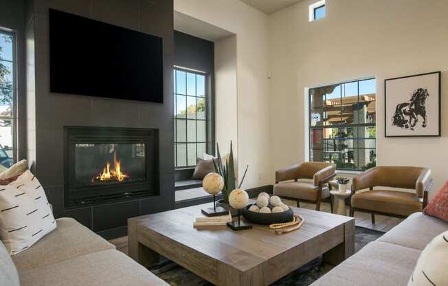 a living room with a fireplace and a tv