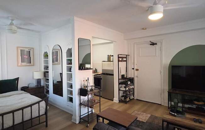 A bedroom with a bed, dresser, and mirror.
