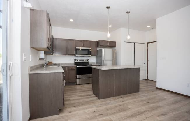 a kitchen with wooden cabinets and stainless steel appliances