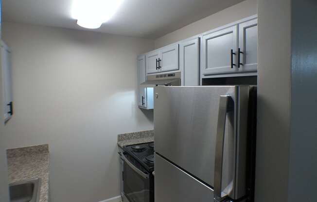 a kitchen with stainless steel appliances and white cabinets