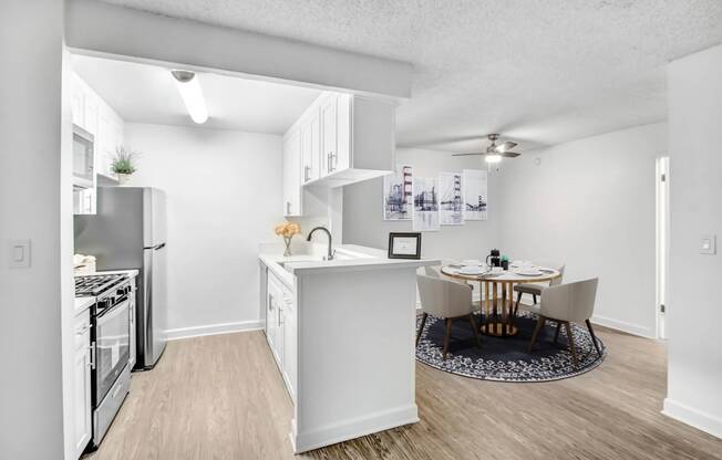 an open kitchen and dining room with a table and chairs