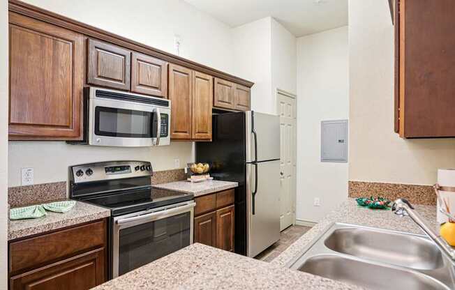 A kitchen with brown cabinets and a stove top oven.