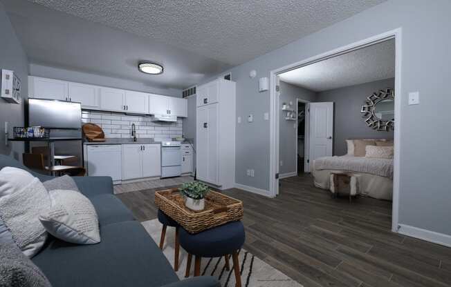 Apartments in Haltom City, TX for Rent - Desert Sands Apartments - Living Room with Stylish Decor and Hardwood Inspired Flooring Leading into the Kitchen and Bedroom