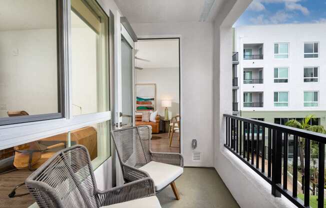 A balcony with a chair and a table.
