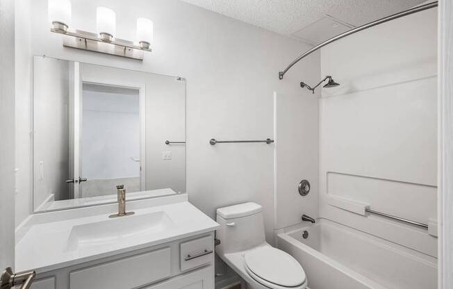 a bathroom with a sink toilet and a bath tub